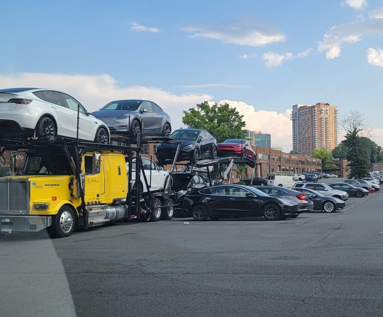 Adcock Transport car carrier truck delivering vehicles across Pennsylvania, New Jersey, and Florida highways.